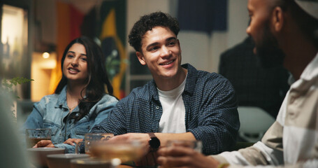 Conversation, friends and people in bar, smile and bonding together with reunion. Group, men and woman in restaurant, discussion and beverage with joke, humor and social gathering with event