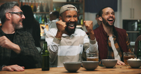 Men, friends and fist pump at sports bar, watching tv or celebration for goal in soccer competition. People, group and excited for cheers, football match or live stream for international game at pub