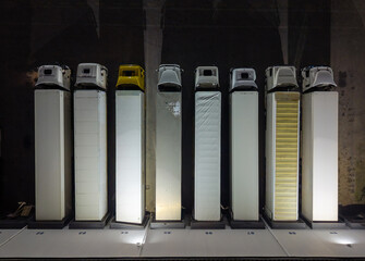 Aerial view captures a row of freight trucks parked at a loading dock under dim overhead lights.