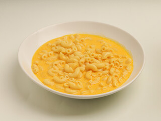 Macaroni and cheese soup in white plate