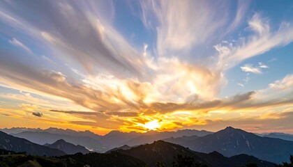 Sunset colors paints dramatic sky above silhouetted mountain range