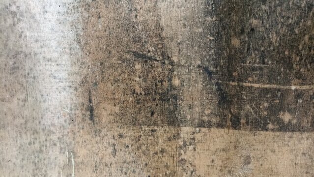 Heavily stained and rotten wooden plank surface covered in dark black mold, damp mildew patterns, and dirt