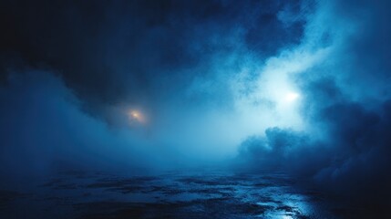 Fototapeta premium A serene, dark blue landscape shrouded in mist, featuring faint lights peeking through, creating a mysterious and atmospheric scene.