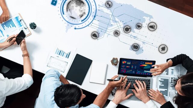 A modern business meeting scene featuring a collaborative team analyzing data on laptops, with digital visualizations overlaying a world map, highlighting teamwork and technology. Raster
