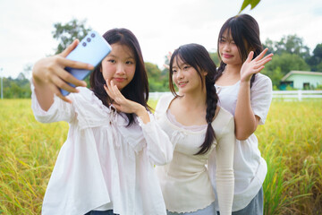 Happy teenage girls taking a cheerful outdoor selfie with a smartphone, expressing friendship, youth lifestyle, connection, and modern social media culture.