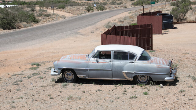 bandoned 1954 Chrysler Windsor Deluxe 4-door sedan along historic route 66 naera Antares, Arizona..