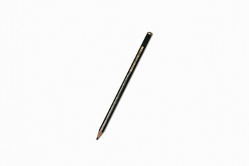 A single black pencil lying on a white surface, photographed in close-up to show its texture and simplicity