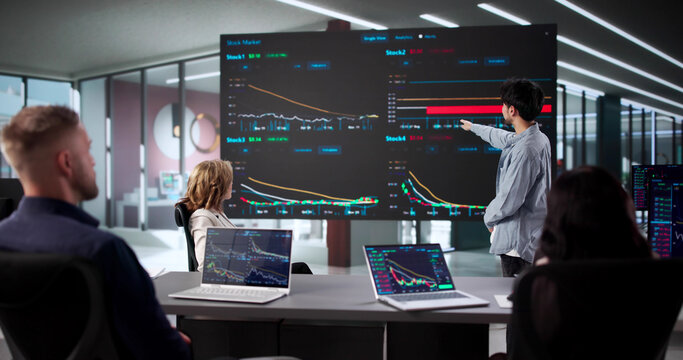 Stock Brokers Analyzing Past Trades - Powered by Adobe