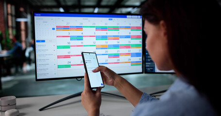 Busy Woman Managing Calendar And Email On Smartphone