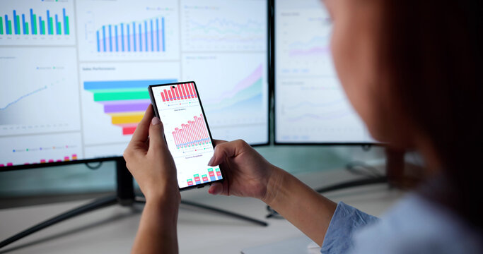 Successful Female Investor Analyzing Mobile Marketing Data - Powered by Adobe