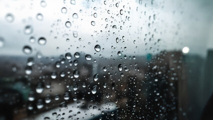 Macro Raindrops on Window with Blurred City Background