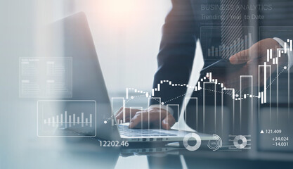 Business, finance and investment concept. Businessman using digital tablet analyzing financial data with economic graph growth chart, Business strategy and planning. market research