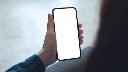 Mockup, blank screen cell phone. Woman hand holding, using mobile phone at home with white empty space for advertise text. contact business, social meida communication, technology device, closeup