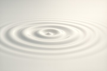 Soft concentric ripples on pure white surface