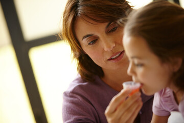 Home, medicine and mother with girl, illness and syrup with help, wellness and cure. Family, parent...