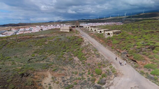Low altitude aerial drone flight over the eerie, derelict buildings of the abandoned Abades Leper Colony and Sanatorium complex in Tenerife, Canary Islands.