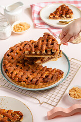 Homemade Apple Pie Slice on Pink Background with Cinnamon and Fresh Apples