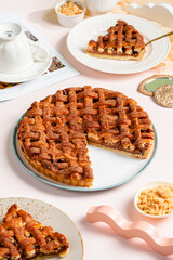 Homemade Apple Pie Slice on Pink Background with Cinnamon and Fresh Apples