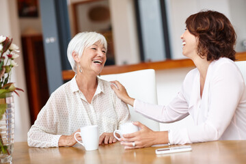 Senior mother, laugh and women with coffee in home for comedy, gossip story or humor. Tea, elderly mom and daughter talking in living room for communication, funny joke and family bonding together
