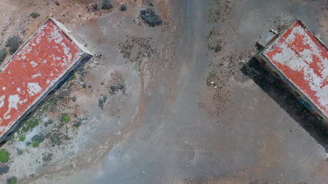 Perfect vertical aerial top-down view over the sprawling, abandoned Abades Leper Colony and Sanatorium ruins complex in Tenerife, Canary Islands, Spain.