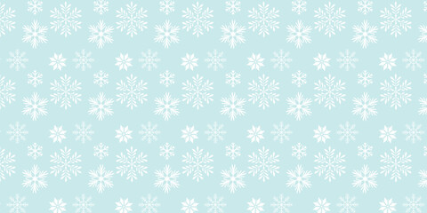 Seamless pattern with white snowflakes on a light blue winter background