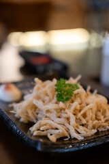 Crispy fried silver fish served on plate, Japanese food.