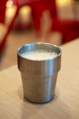 A cup of hot milk on wooden table
