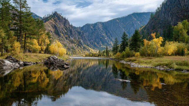 Siberian autumn landscape with golden trees reflecting in the irkut river, eastern sayan mountains in the baikal region, buryatia, tunka valley scenery