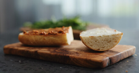 ciabatta sandwich with red pesto and cream cheese on terrazzo countertop