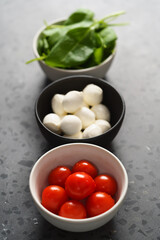 ingredients for salad, mozzarella, spinach and cherry tomatoes