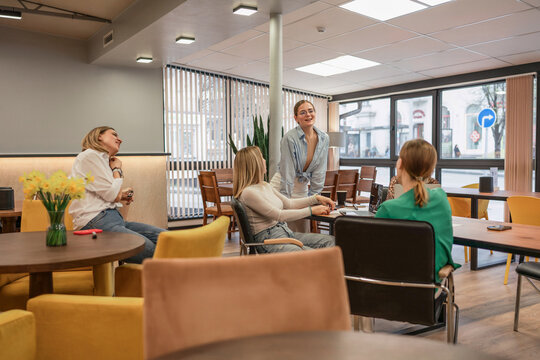 Women collaboration office, young professionals discussing strategy during a casual modern team meeting.