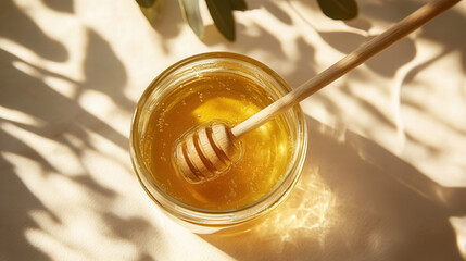 Close-up of a jar of golden honey with a wooden dipper, warm lighting and shadows, natural texture, concept