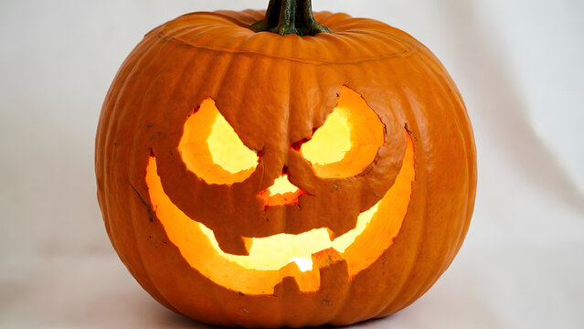 Glowing jack-o’-lantern shining with spooky Halloween magic, carved to create eerie festive charm.