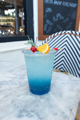 Refreshing cocktail with cherry and orange slice