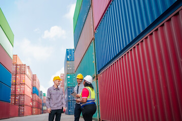 A logistics supervisor gives staff a detailed briefing on cargo verification, and safety compliance. With shipping containers towering behind them, the efficient and reliable supply chain operations.