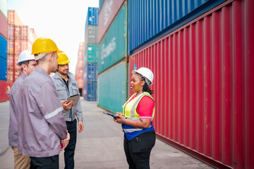A multicultural logistics team receives on-site instructions for container handling and freight...
