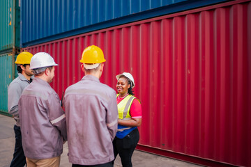 A diverse team of warehouse workers listens to instructions regarding freight inspection and export preparation, highlighting accurate and organized workflow.