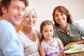 Food, portrait and smile with family at lunch for bonding, nutrition and thanksgiving event. Grandmother, girl and social gathering with dad in dining room at home for love, celebration or brunch