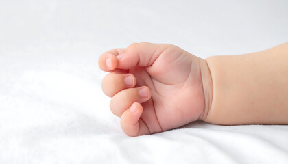 Tiny Hand, Big Love A Close-Up of a Baby's Adorable Fingers on White Fabric