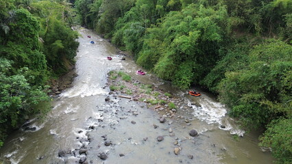 Rafting Adventure Navigating the Rapids in River Surrounded by Lush Greenery