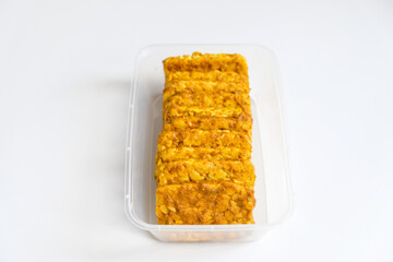 Tempeh yellow spices in plastic containers for stock in refrigerator