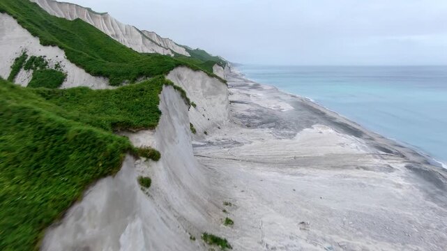 Russia, Kuril Islands, Iturup Island, White rocks on the coast of the Sea of Okhotsk. Aerial view.
