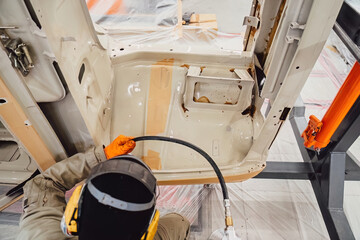 Professional anti corrosion undercoating treatment applied to hidden cavities of a car body. Long lasting metal protection and technical maintenance for extended vehicle lifespan.