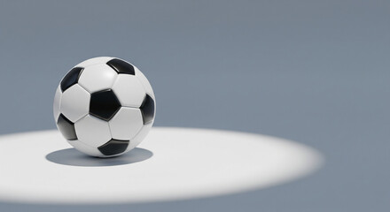 Soccer ball on a white surface illuminated by a spotlight perfect for sports-related advertising and promotional materials