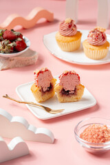 A Cupcake is a small, single-serving cake baked in a small cup-shaped mold, often lined with paper