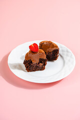 A Cupcake is a small, single-serving cake baked in a small cup-shaped mold, often lined with paper