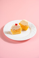 A Cupcake is a small, single-serving cake baked in a small cup-shaped mold, often lined with paper