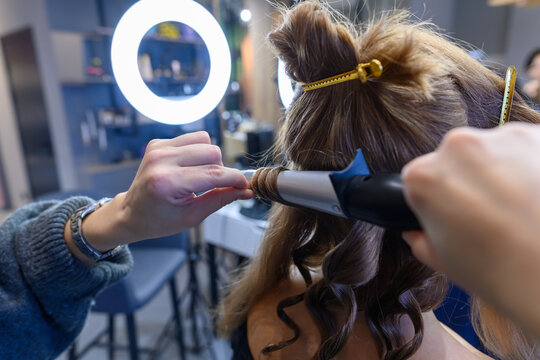 Transforming beauty with expert hairstyling in a modern salon setting - Powered by Adobe
