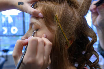 Fototapeta premium Beauty transformation in a salon with skilled makeup application