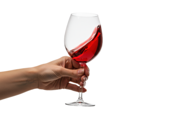 Macro close-up of an elegant caucasian woman's hand with clear manicure gripping a tilted crystal glass of vibrant ruby red wine on a high-key white background with copy space. concept for luxury